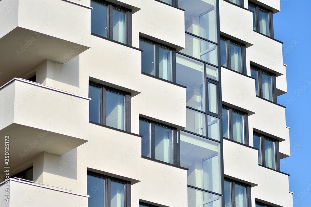 Modern white building with balcony on a blue sky