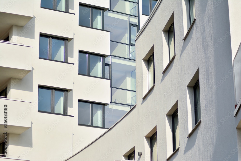 Modern white building with balcony on a blue sky