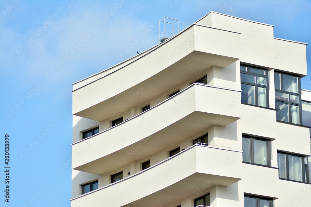 Modern white building with balcony on a blue sky