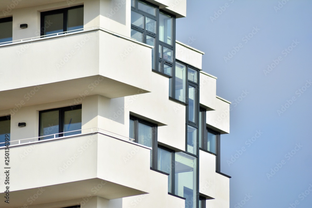 Modern white building with balcony on a blue sky