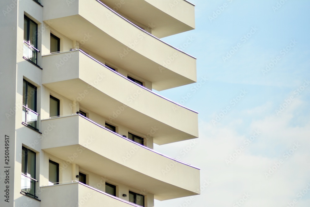 Modern white building with balcony on a blue sky