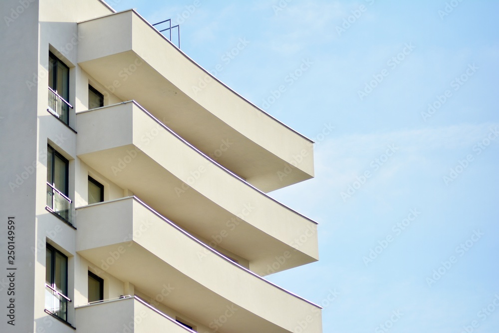 Modern white building with balcony on a blue sky