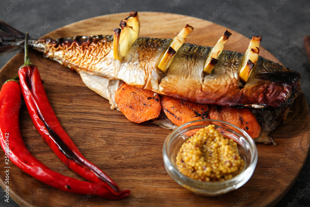 Tasty mackerel fish with vegetables and sauce on plate