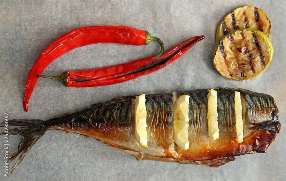 Tasty mackerel fish with vegetables on board