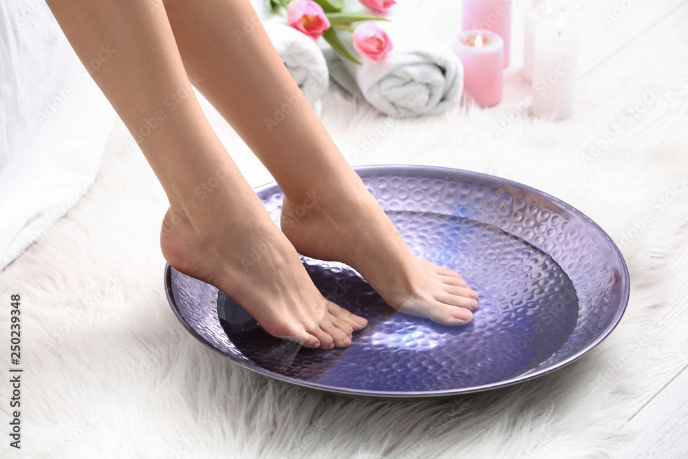 Young woman getting pedicure in beauty salon