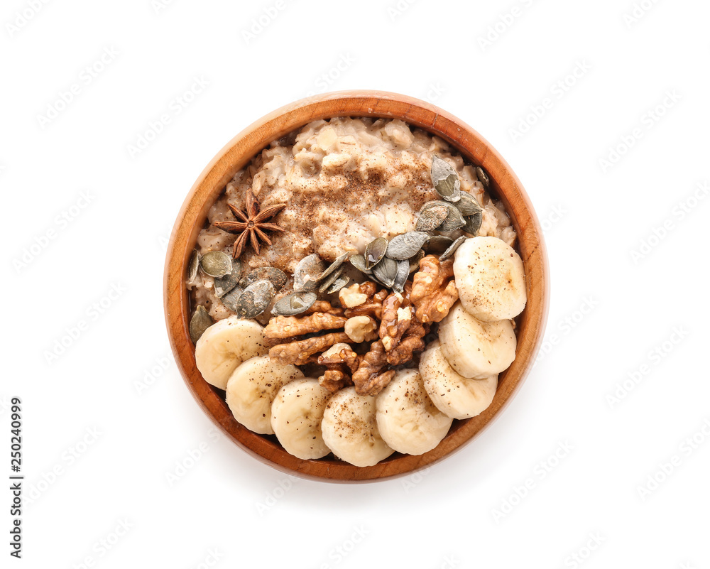 Bowl with tasty oatmeal on white background