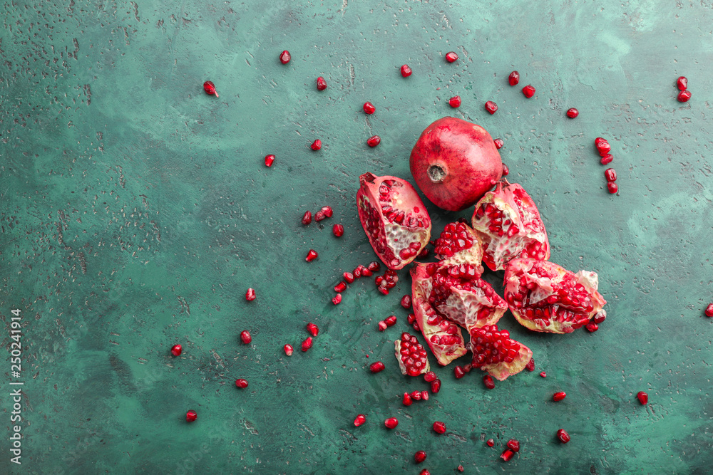 Pieces of ripe pomegranates on color table