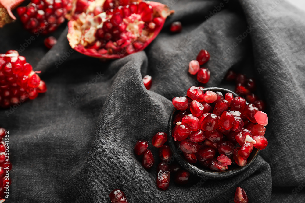 Bowl with seeds of ripe pomegranate on table