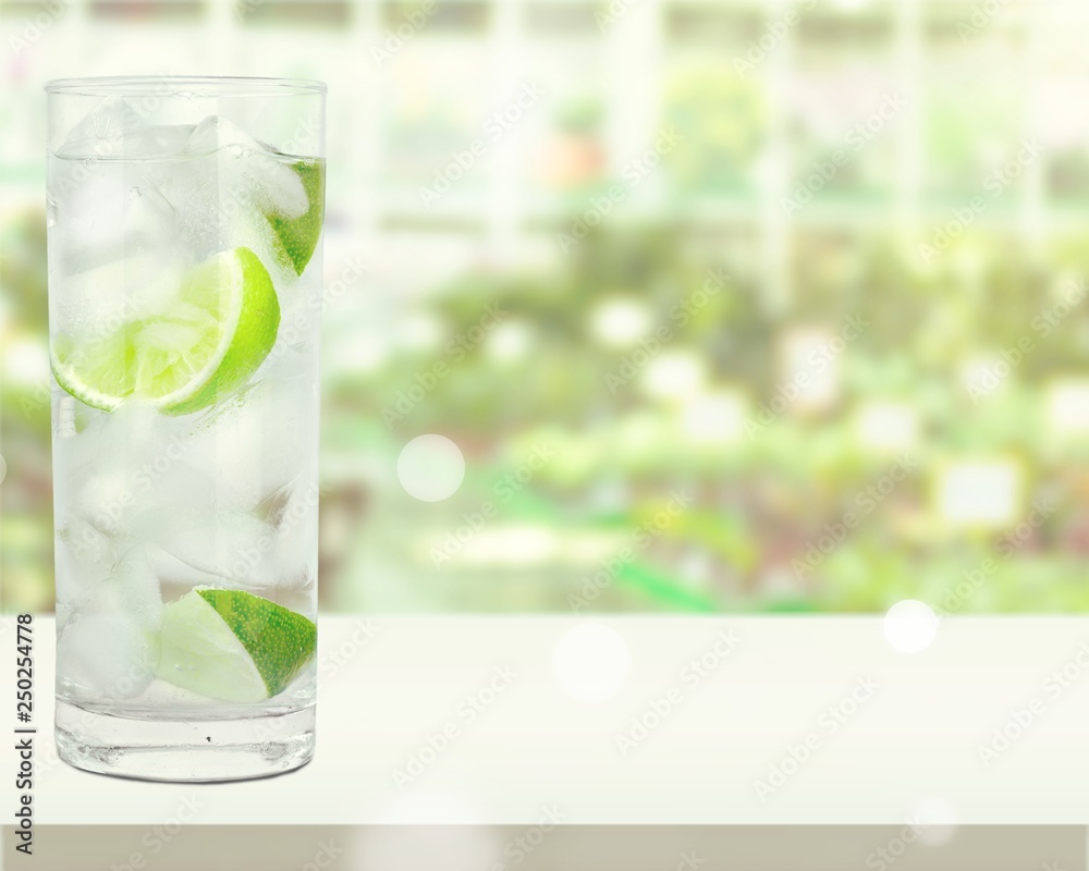 Glasses with fresh organic cucumber water on wooden table, on grey background