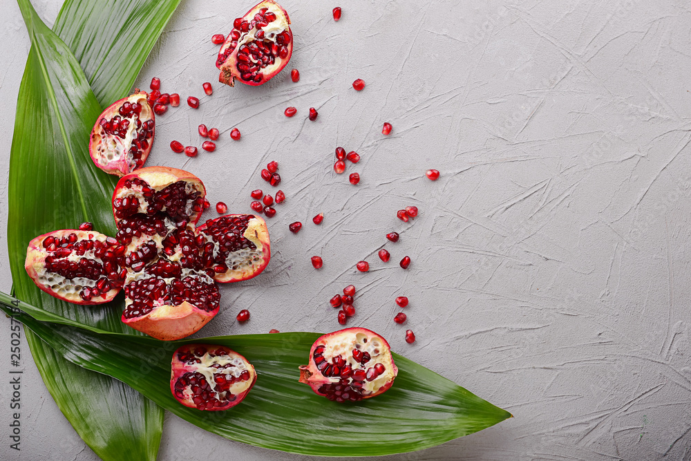 Ripe pomegranates on grey background