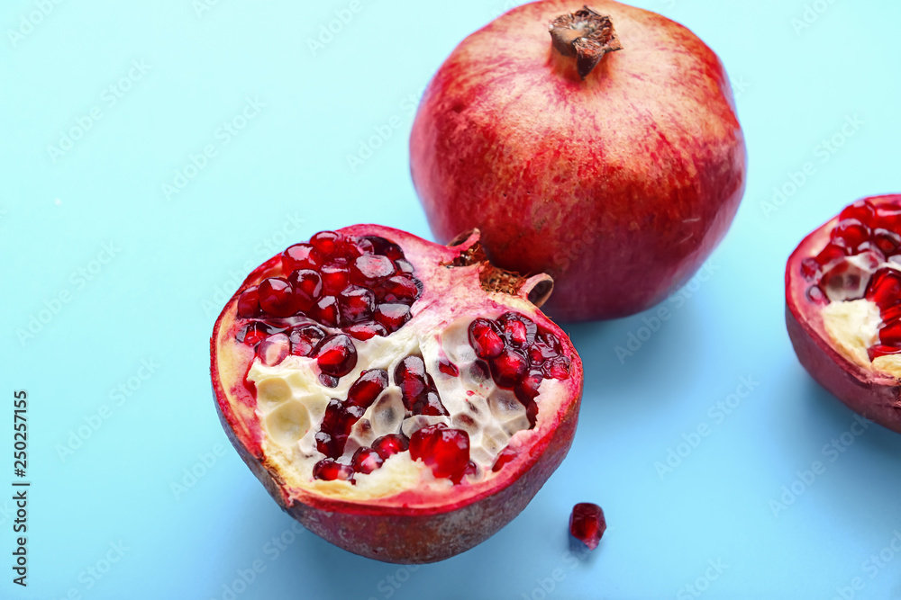 Ripe pomegranates on color background