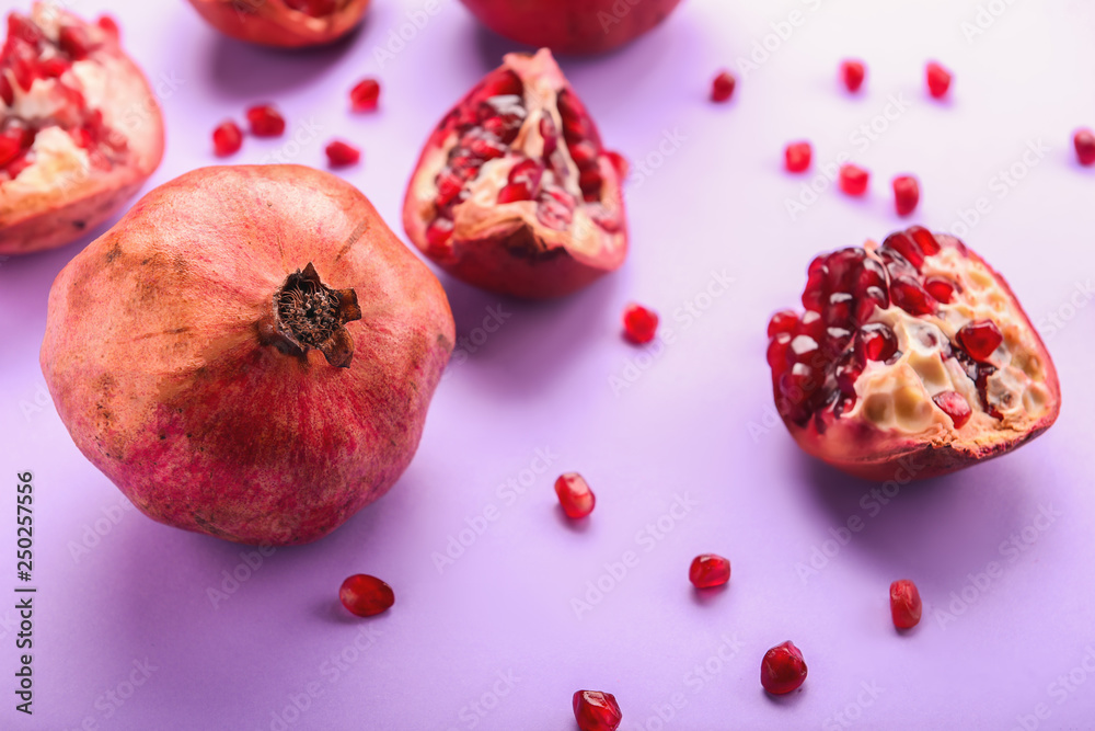 Ripe pomegranates on color background