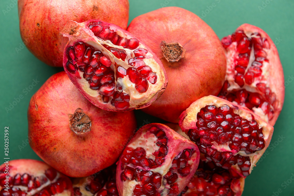 Ripe pomegranates on color background