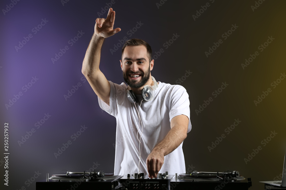 Male DJ playing music in club