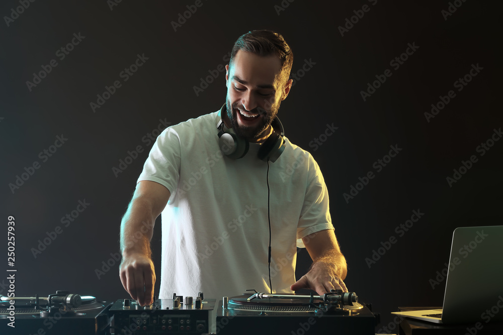 Male DJ playing music in club