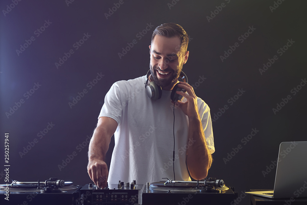 Male DJ playing music in club