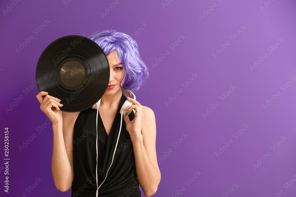 Beautiful young woman with vinyl disk and headphones on color background