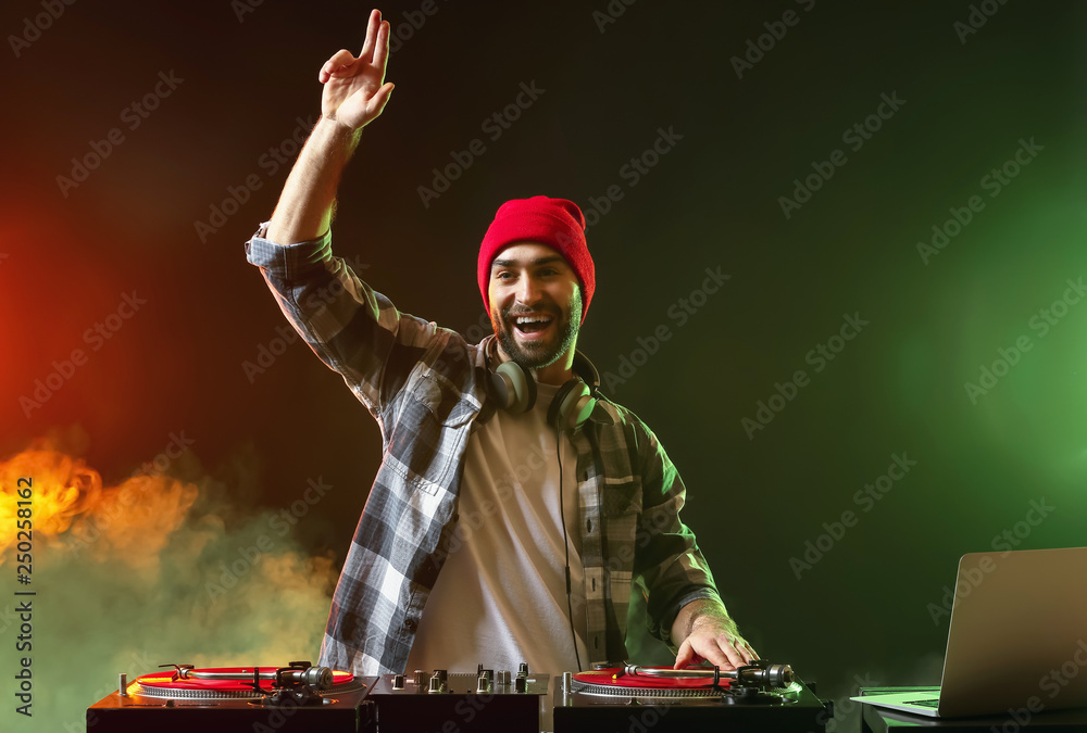 Male DJ playing music in club