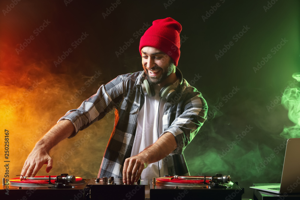 Male DJ playing music in club