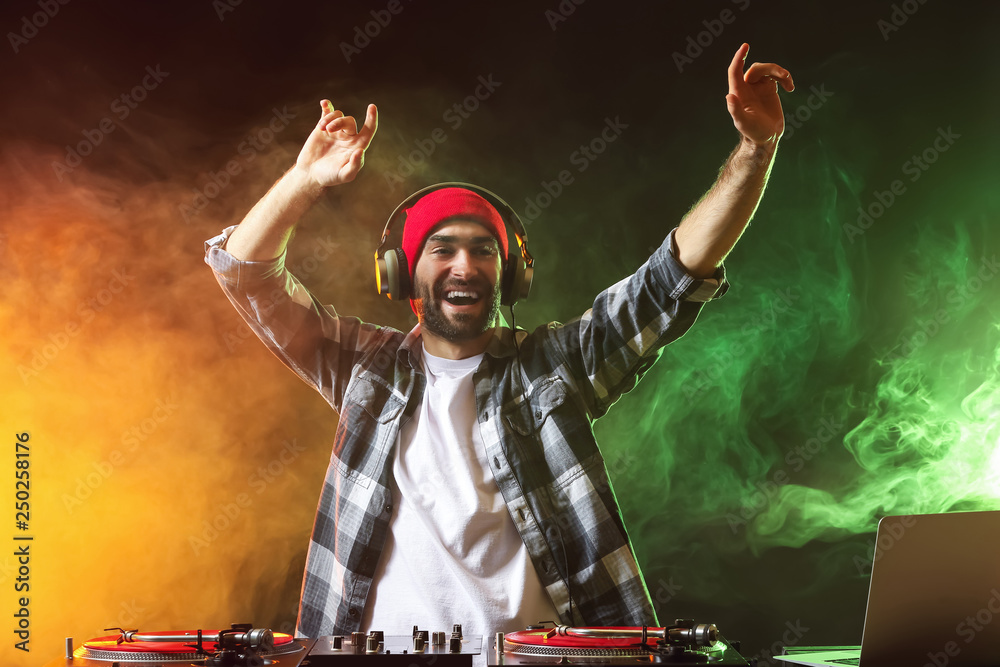 Male DJ playing music in club