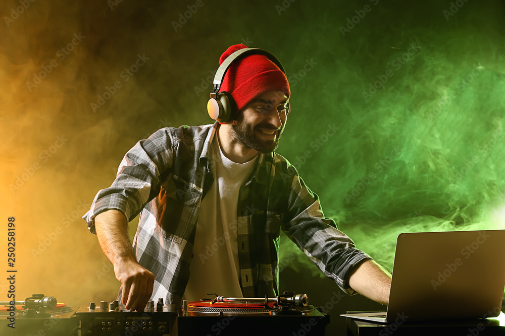 Male DJ playing music in club