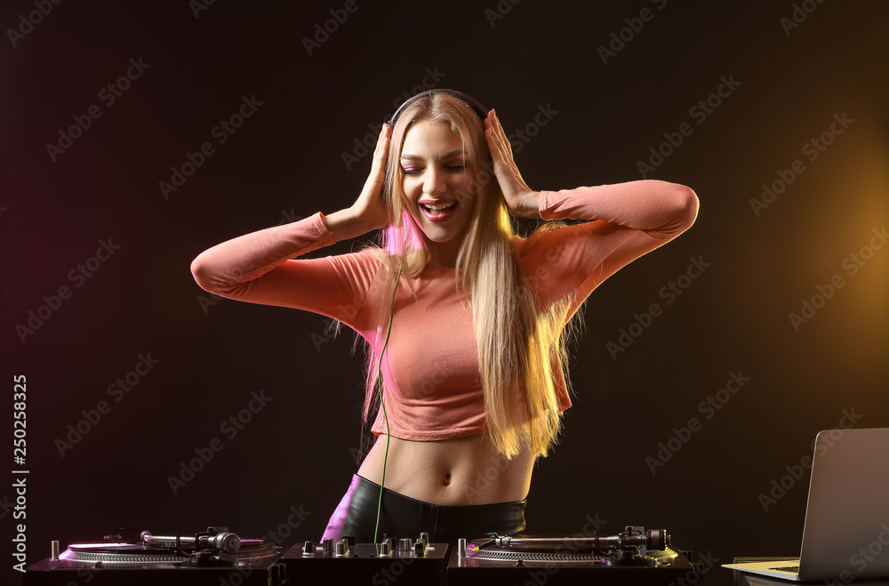 Female DJ playing music in club