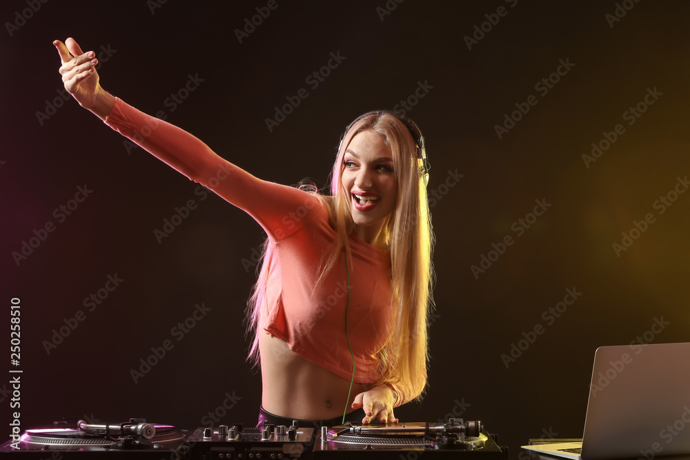 Female DJ playing music in club