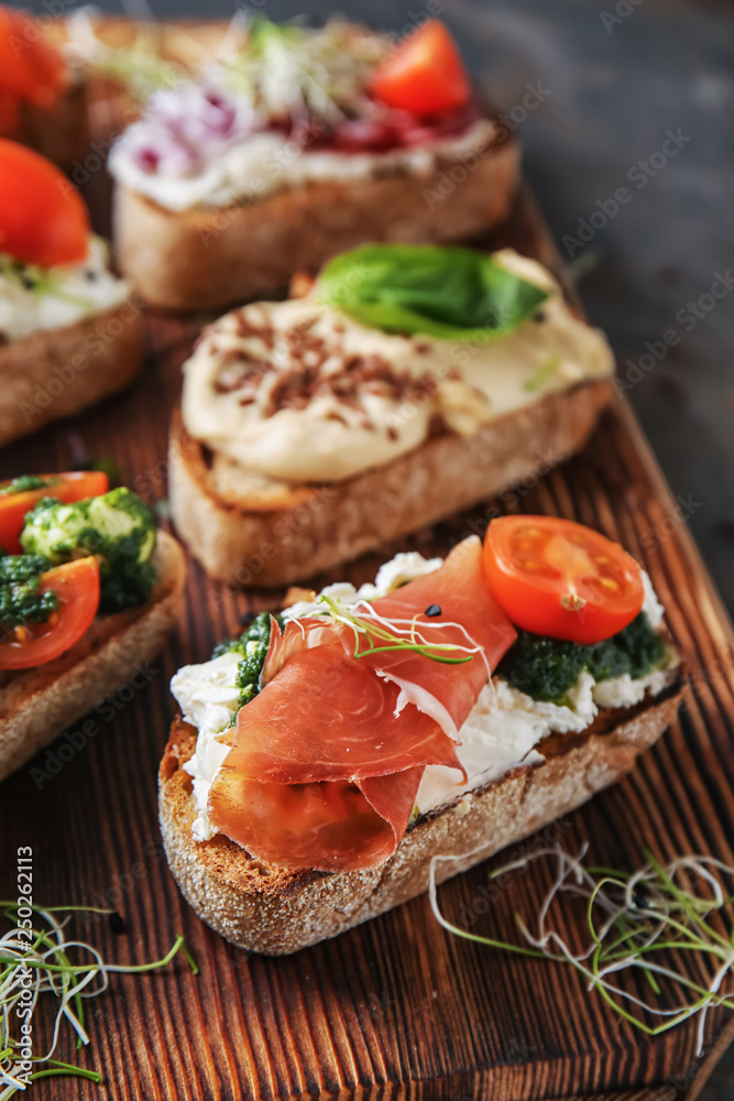 Fresh tasty bruschettas on wooden board