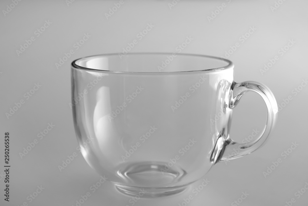 Empty glass cup on light background