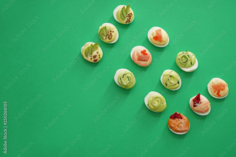 Tasty deviled eggs on color background