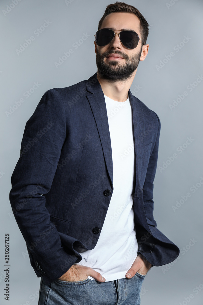 Handsome fashionable man on grey background