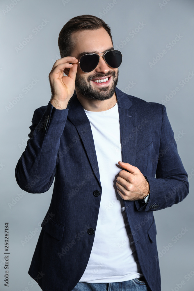 Handsome fashionable man on grey background