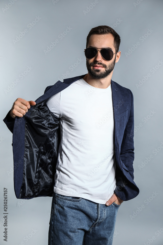 Handsome fashionable man on grey background