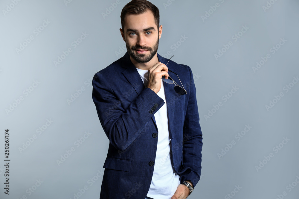 Handsome fashionable man on grey background