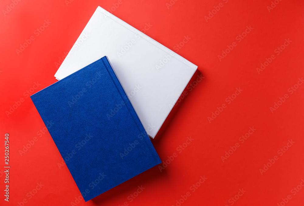 Books with blank covers on color background