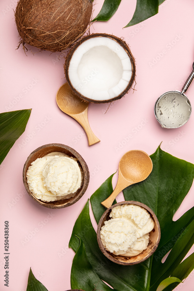 Creative flat lay with coconut ice cream and tropical plants