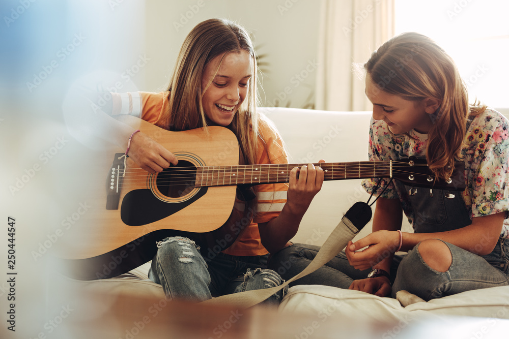 Girls having fun learning guitar