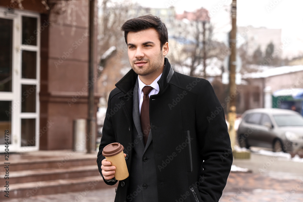 Portrait of handsome young businessman outdoors