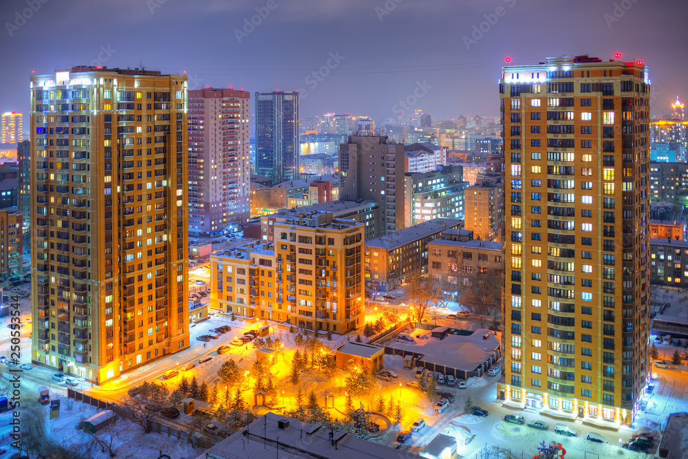 Beautiful top view of the city. Colorful street lighting of the night metropolis. Many high-rise bui