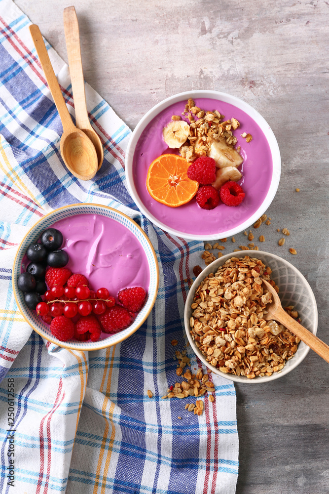 Composition with tasty acai smoothie bowls on table