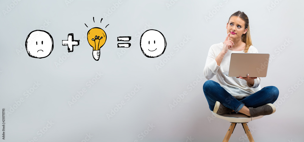 Good idea equals happy with young woman using her laptop on a grey background