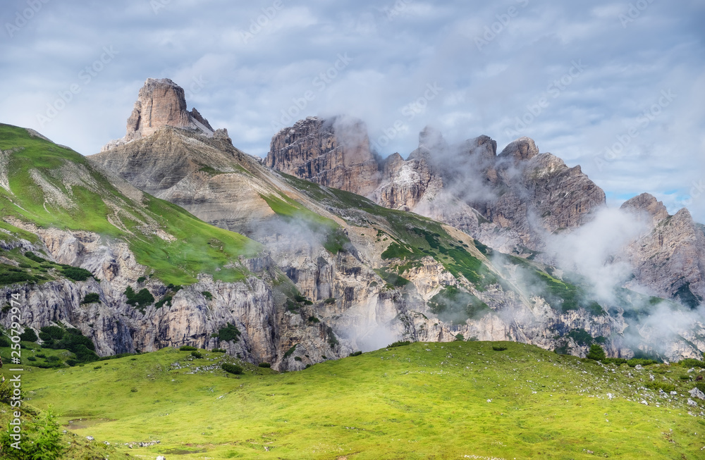 Mountain panorama in the Dolomite Alps, Italy. Mountain ridge in the clouds. Beautiful landscape at 