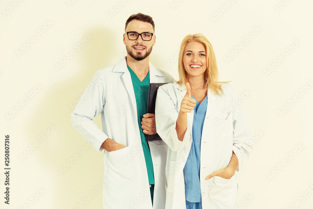 Portrait of confident doctors on white background.