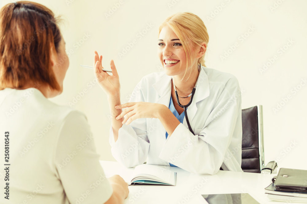 Woman Doctor and Female Patient in Hospital Office