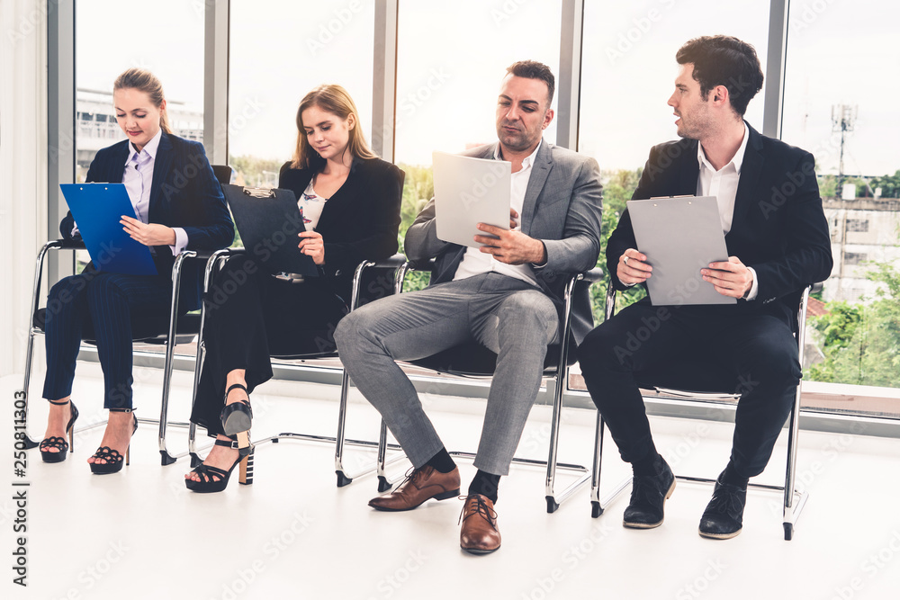 Businesswomen and businessmen wait for interview.