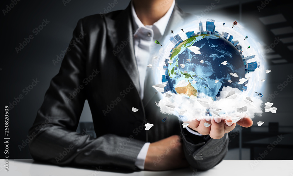 Businessman presenting Earth globe.