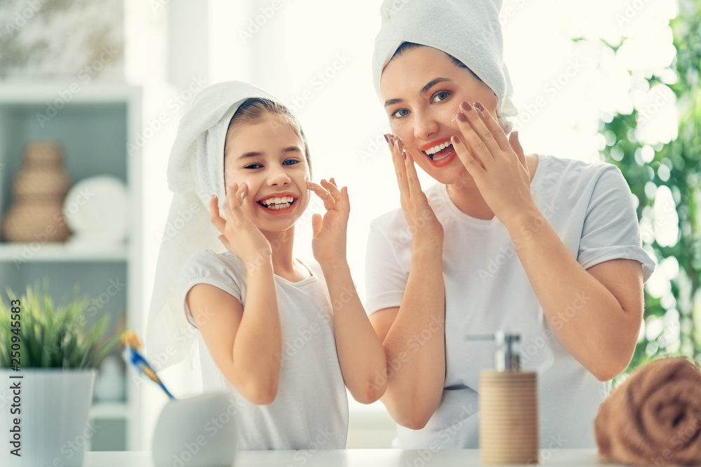 Mother and daughter caring for skin