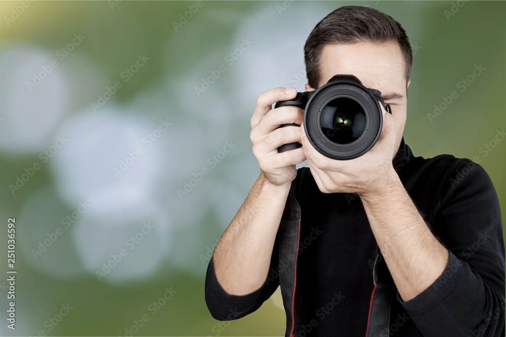 Male Photographer with Camera on grey background