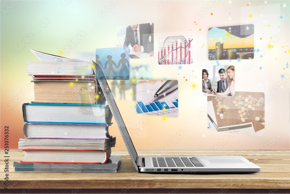 Stack of books with laptop