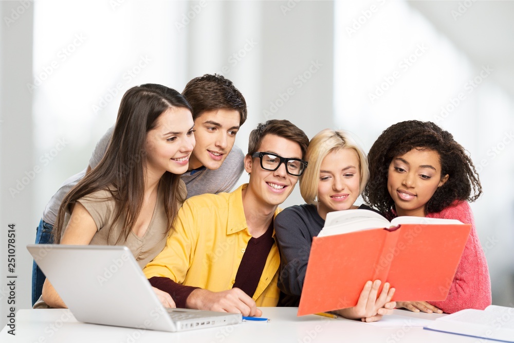 Young students studying on library background